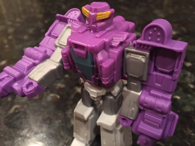 A close up image of a small, purple, plastic toy of a transformer robot. I just went digging through my kid's toy chest and snapped this picture on my kitchen counter. It's a bot, this article is about bots. Get it?