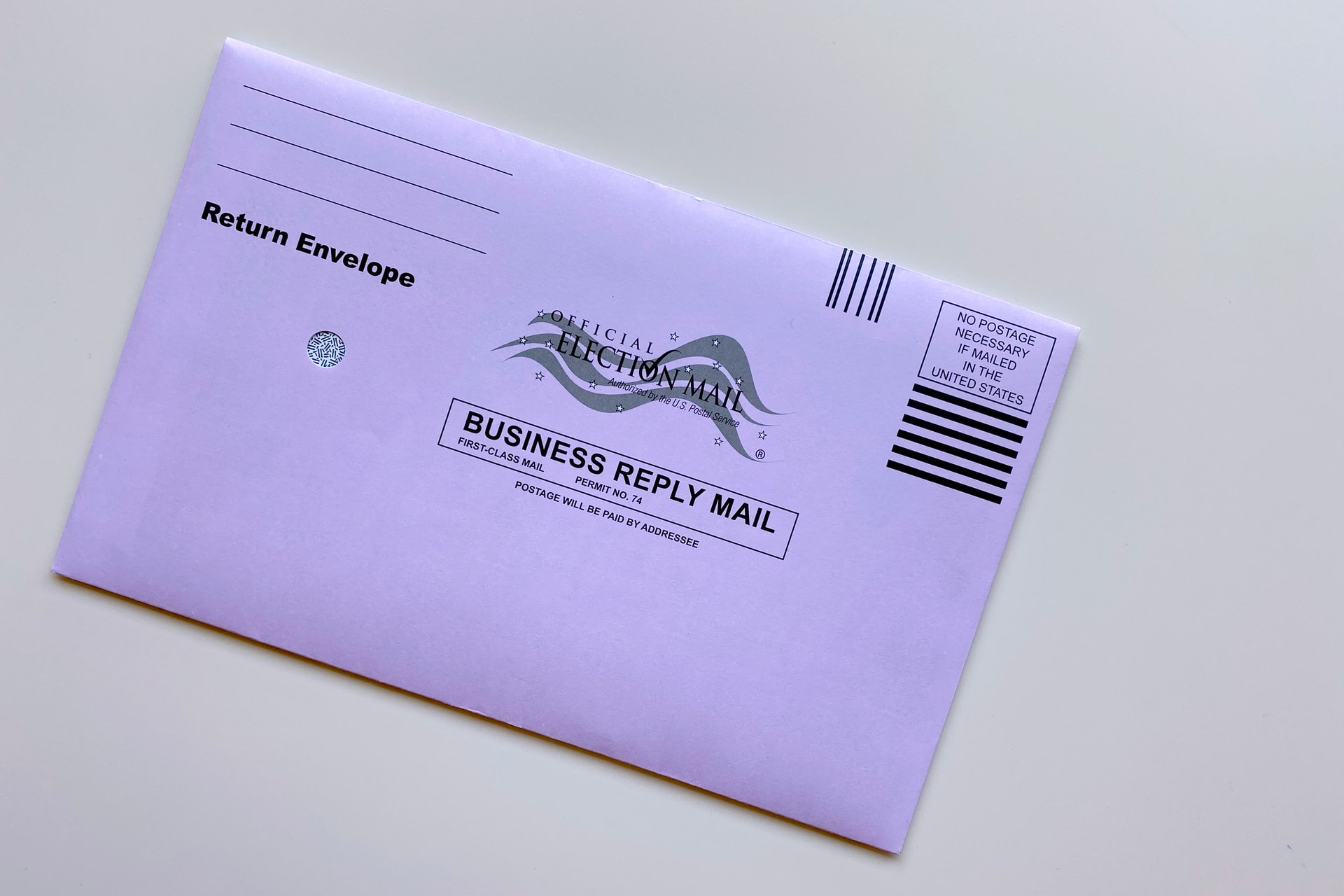 An absentee ballot envelope laying on a white background. 