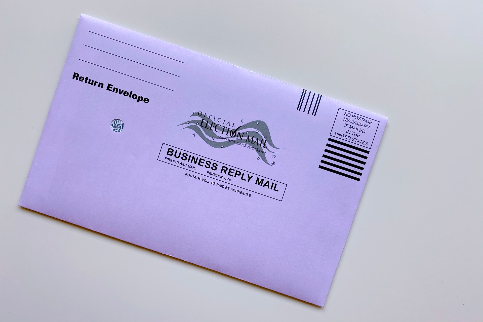 An absentee ballot envelope laying on a white background.